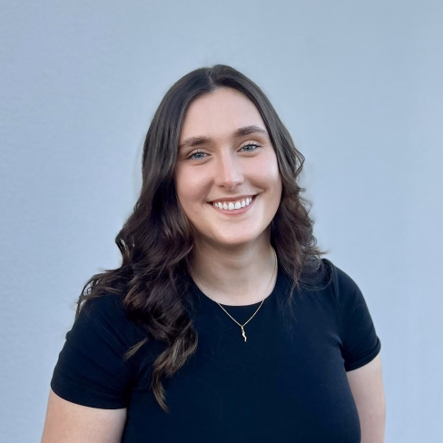 A photo of Dayna showing a warm, welcoming smile